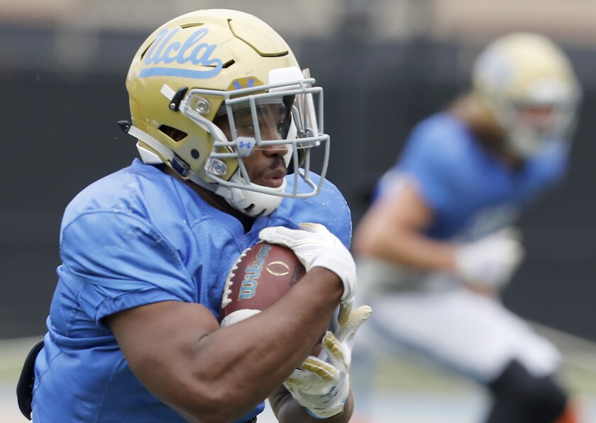 UCLA running back Martell Irby takes the ball upfield during the annual spring intrasquad football game at Drake Stadium in Westwood on April 20.