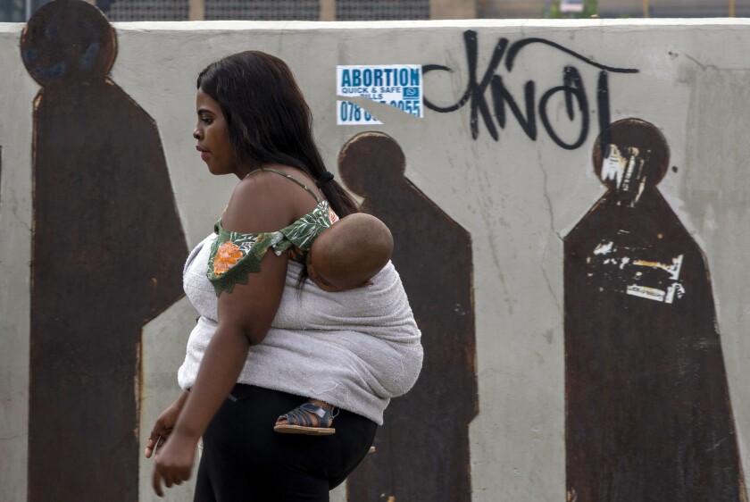 A pedestrian and her baby in Johannesburg, South Africa, earlier this year.