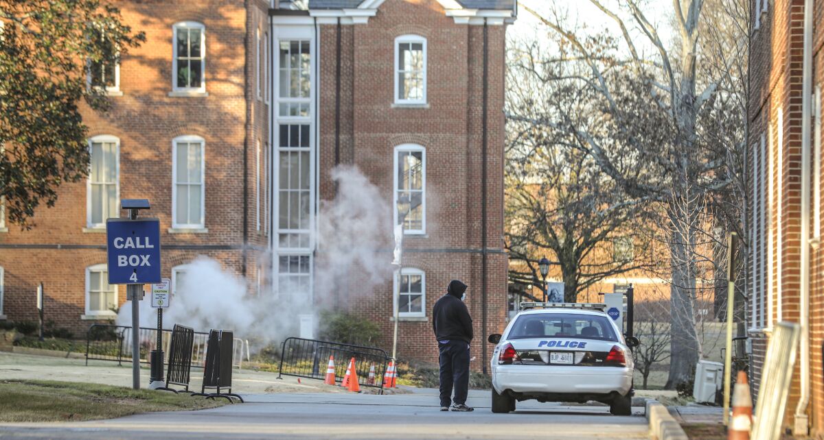 A man speaks with a police officer in a patrol vehicle outside the Spelman campus Tuesday morning, Feb. 1, 2022 after two historically Black colleges in Georgia received bomb threats Tuesday morning, a disturbing trend that many HBCUs across the country have been threatened with in recent weeks. Fort Valley State University and Spelman College were among several HBCUs nationwide that received threats, according to published reports. The Atlanta University Center Consortium, a partnership of the city's HBCUs, said it is working with public safety teams on each campus to ensure the safety of students, faculty and staff. (John Spink/Atlanta Journal-Constitution via AP)