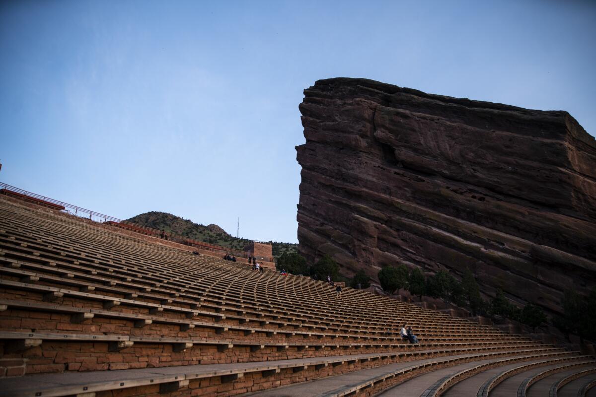 People gather to watch the sunrise from the Red Rocks Amphitheatre. (Kent Nishimura / Los Angeles Times)