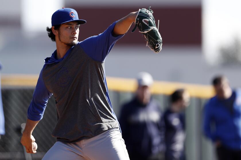 Chicago Cubs pitcher Yu Darvish throws during a spring training baseball workout Wednesday, Feb. 12, 2020, in Mesa, Ariz. (AP Photo/Gregory Bull)