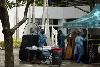 FILE - People are tested for COVID-19, at a walk-up testing site run by Nomi Health, Tuesday, Dec. 28, 2021, in downtown Miami. More than a year after the vaccine was rolled out, new cases of COVID-19 in the U.S. have soared to the highest level on record at over 265,000 per day on average, a surge driven largely by the highly contagious omicron variant. (AP Photo/Rebecca Blackwell, File)