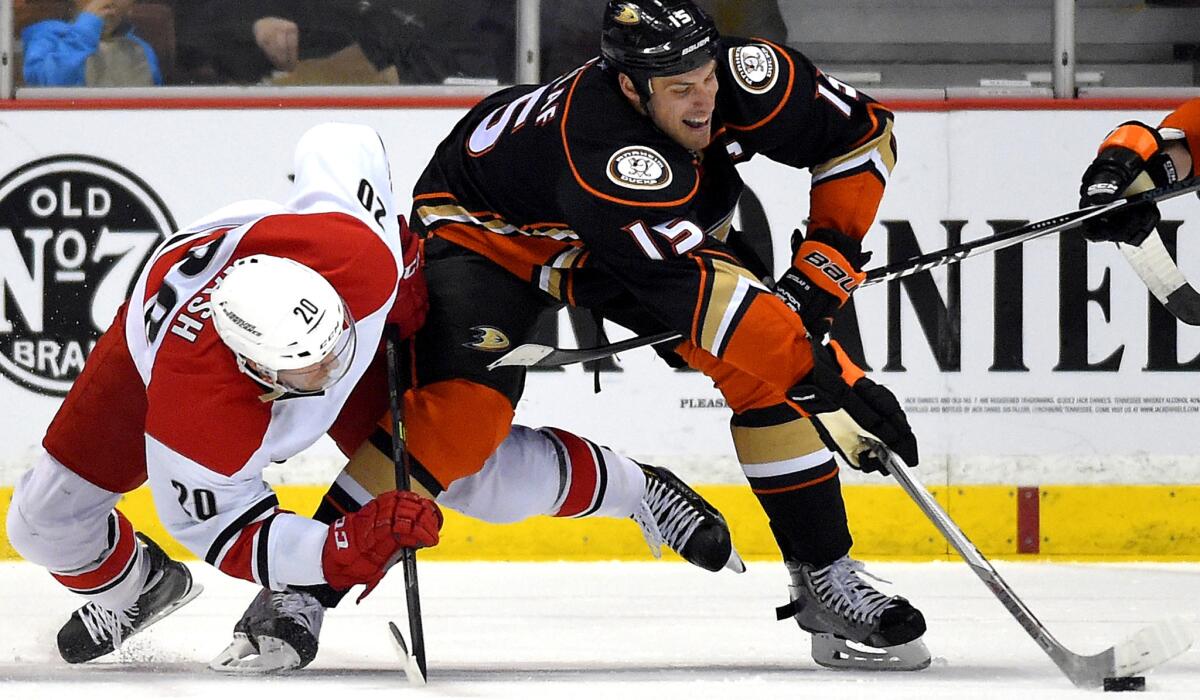 Ducks center Ryan Getzlaf, battling Hurricanes center Riley Nash for the puck on Tuesday, is still questionable to play because of a lower-body injury.