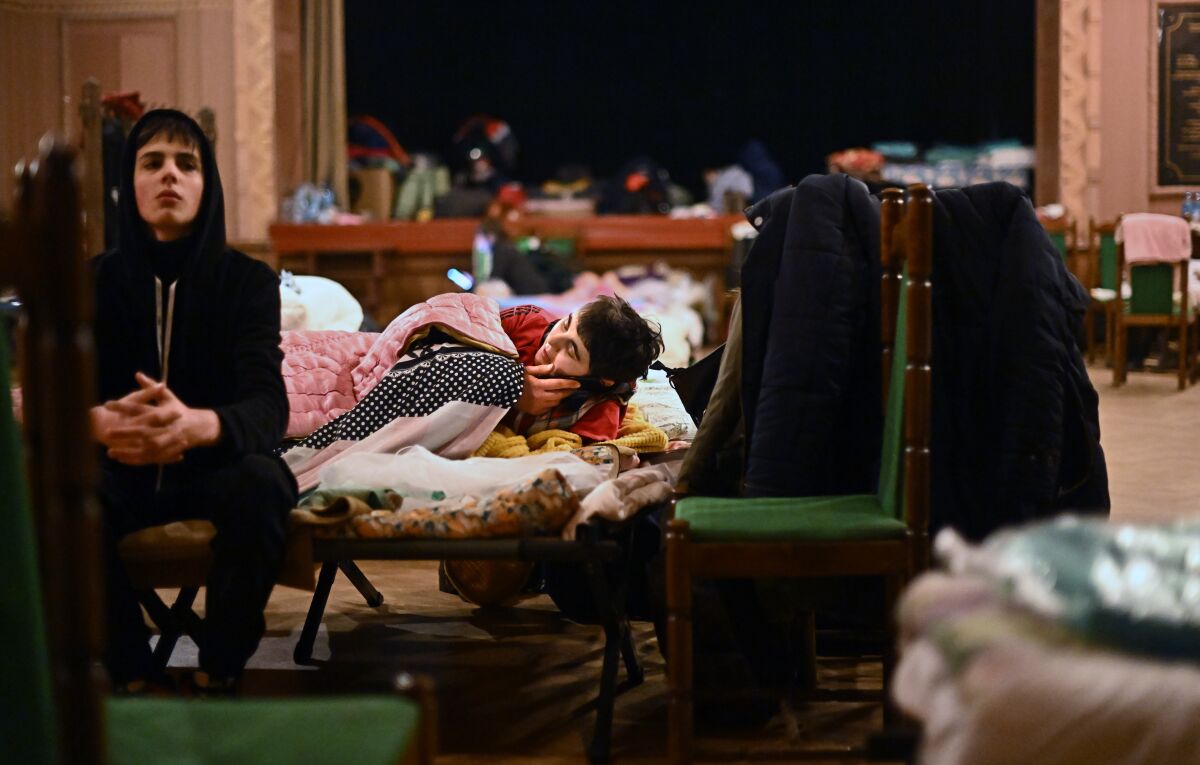 Refugees rest at a shelter.
