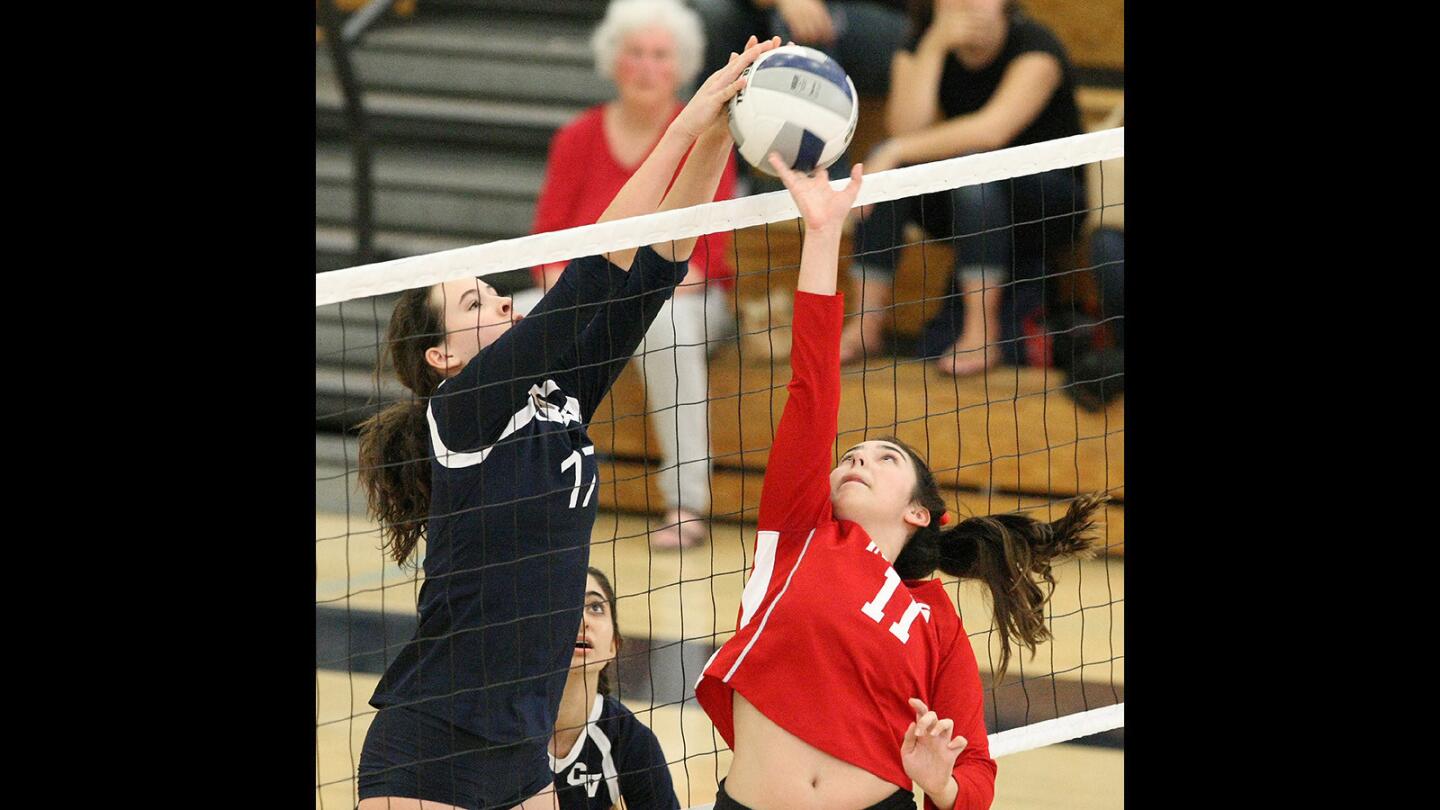 CV's Annamarie Alvarez blocks as Burroughs' Ali Perez tries to tip the ball over the net during a match on Tuesday, October 18, 2016.