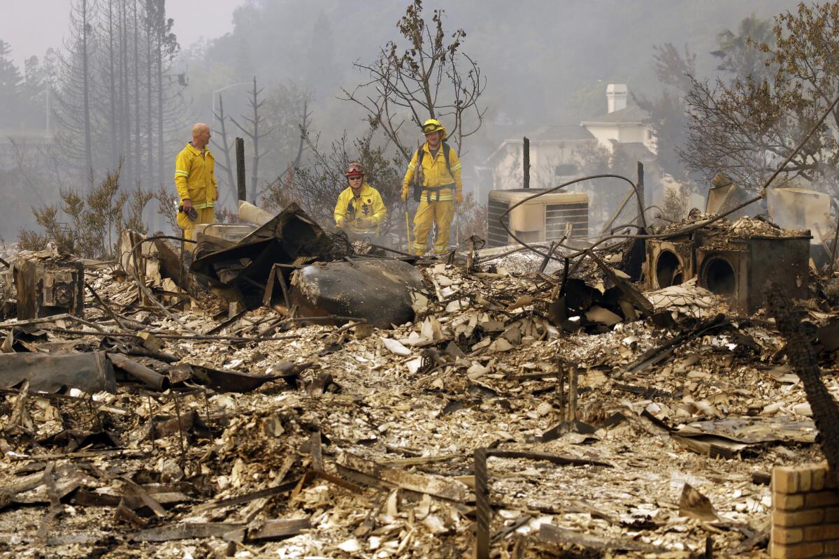 Firefighters look for hot spots in the Fountaingrove area of Santa Rosa, Calif., on Monday.