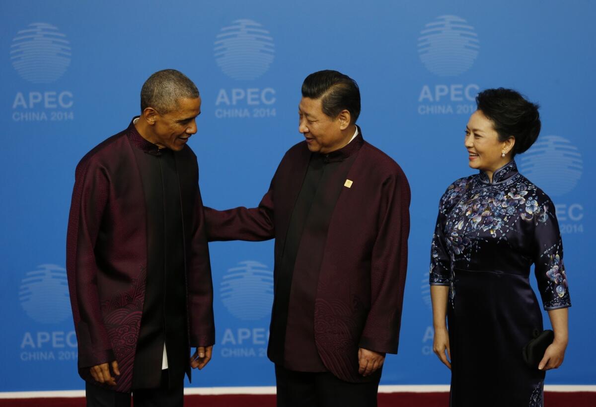 President Obama is greeted by Chinese President Xi Jinping and his wife, Peng Liyuan, at the Beijing National Aquatics Center in Beijing on Nov. 10.