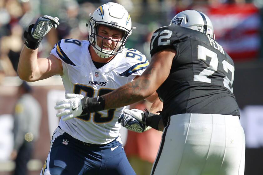 San Diego Chargers Joey Bosa rushes against Raiders Donald Penn in the 3rd quarter in Oakland on Oct. 9, 2016. (Photo by K.C. Alfred/The San Diego Union-Tribune)