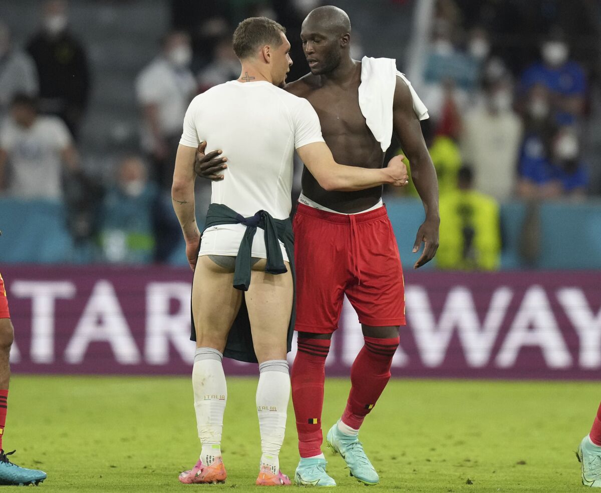 Italy's Andrea Belotti, left, and Belgium's Romelu Lukaku hug after the Euro 2020 soccer championship quarterfinal match between Belgium and Italy at the Allianz Arena stadium in Munich, Germany, Friday, July 2, 2021. (AP Photo/Matthias Schrader, Pool, File)