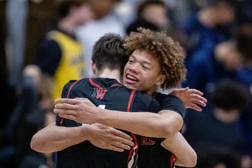 Trent Perry gives a hug to Brady Dunlan after Harvard-Westlake double overtime win over Sherman Oaks Notre Dame.
