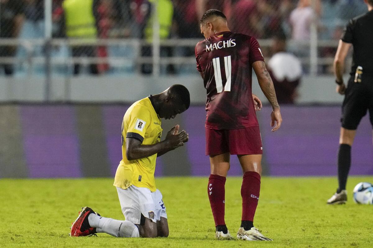 Moisés Caicedo, de la selección de Ecuador, se arrodilla junto a Darwin Machis, de Venezuela