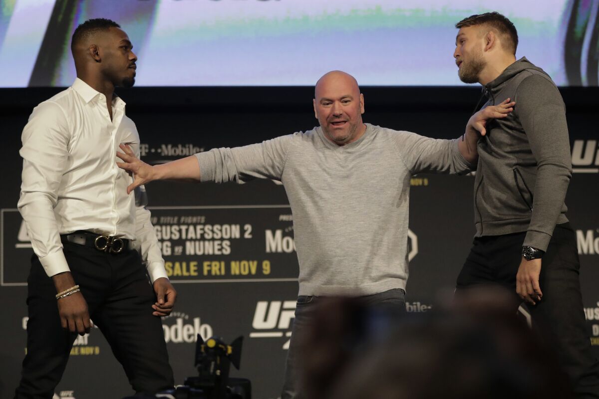UFC president Dana White, center, breaks up Jon Jones, left, and Alexander Gustafsson during a news conference talking about their light heavyweight mixed martial arts bout, Friday, Nov. 2, 2018, at Madison Square Garden in New York. Jones and Gustafsson are to fight in UFC 232, which is scheduled for Dec. 29, 2018, in Las Vegas.