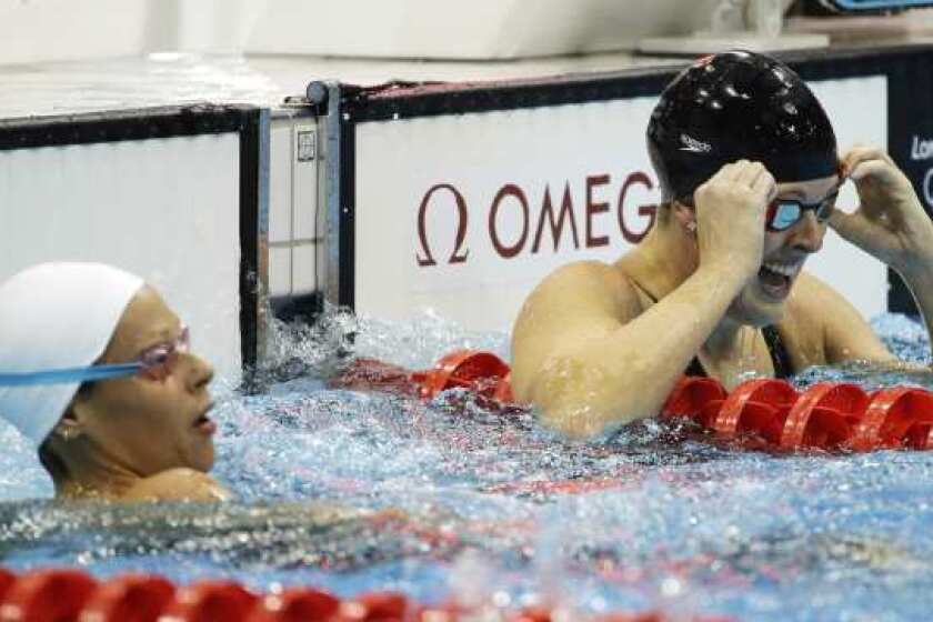 Allison Schmitt, right, reacts after winning the gold medal.