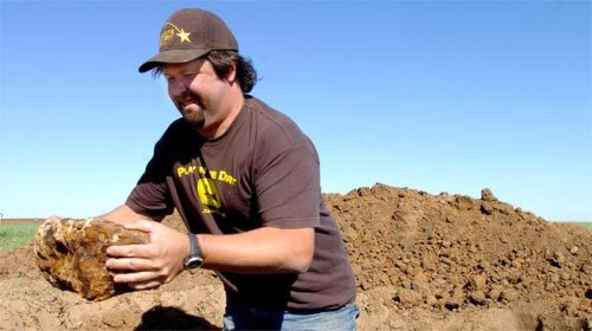 SUCCESS: Steve Arnold finds another meteorite in a field near Haviland. He has found 33 space rocks in Kansas, making farmers who share the profits happy.