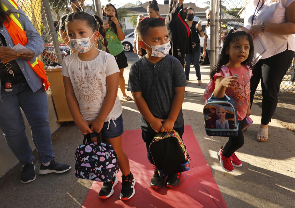 Isabella Sosa, 5, and her brother Daniel Sosa, 4, look around on the first day of school at Vena Avenue Elementary in Arleta.