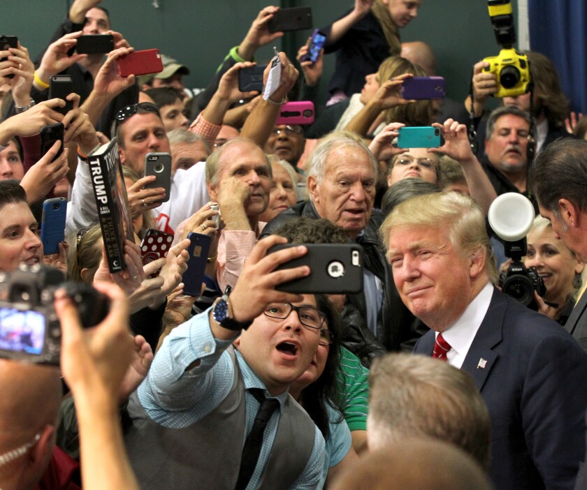 Donald Trump poses for a fan after speaking Monday in South Carolina.