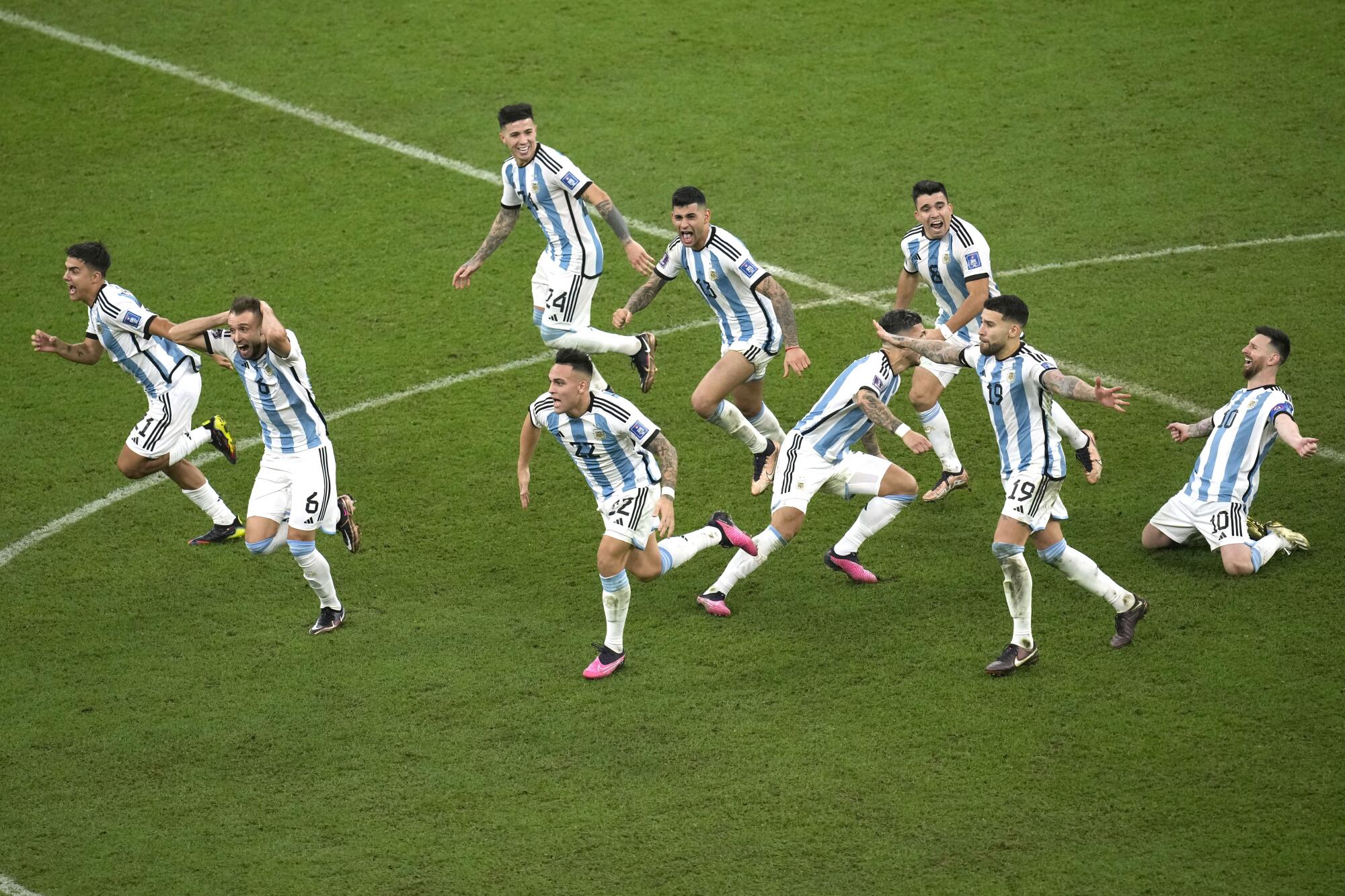 Argentina's players celebrate their victory at the end of the World Cup final.