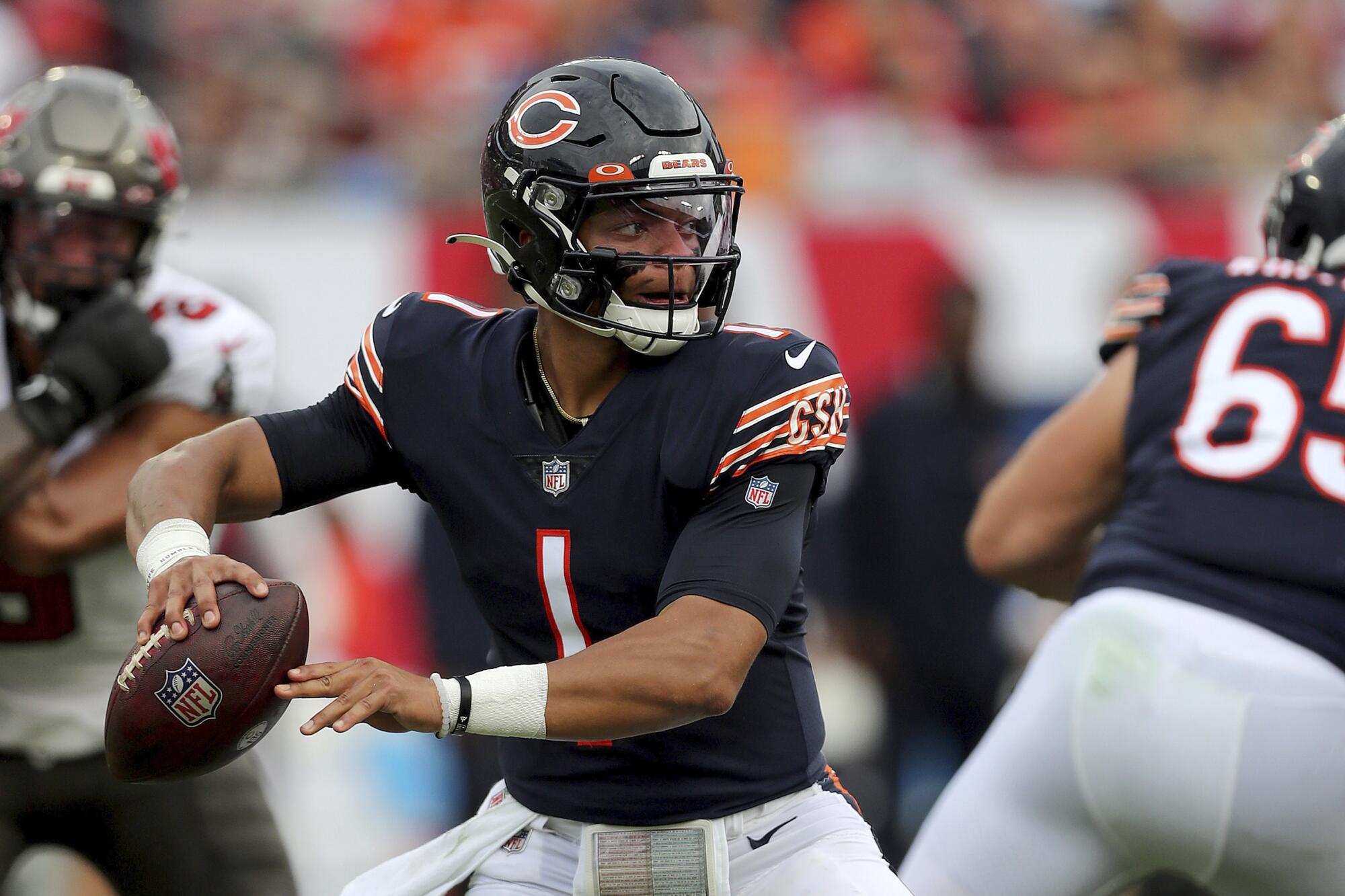 Chicago Bears quarterback Justin Fields attempts a pass during a game against the Tampa Bay Buccaneers.