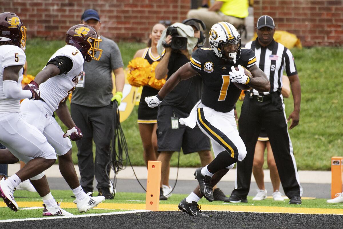 Missouri running back Tyler Badie, front right, scores a touchdown in front of Central Michigan's Alonzo McCoy (3) and Devonni Reed during the first half of an NCAA college football game Saturday, Sept. 4, 2021, in Columbia, Mo. (AP Photo/L.G. Patterson)