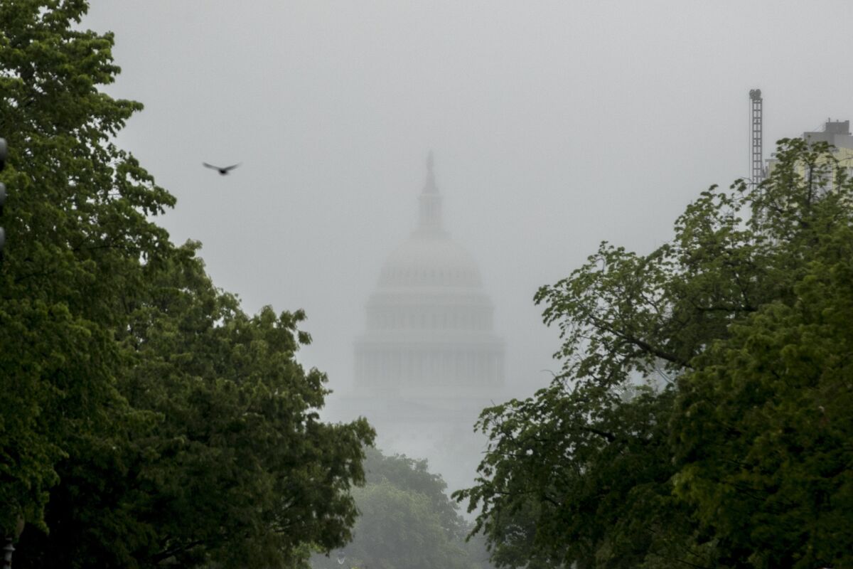 The dome of the U.S. Capitol Building is visible through heavy fog in Washington. 