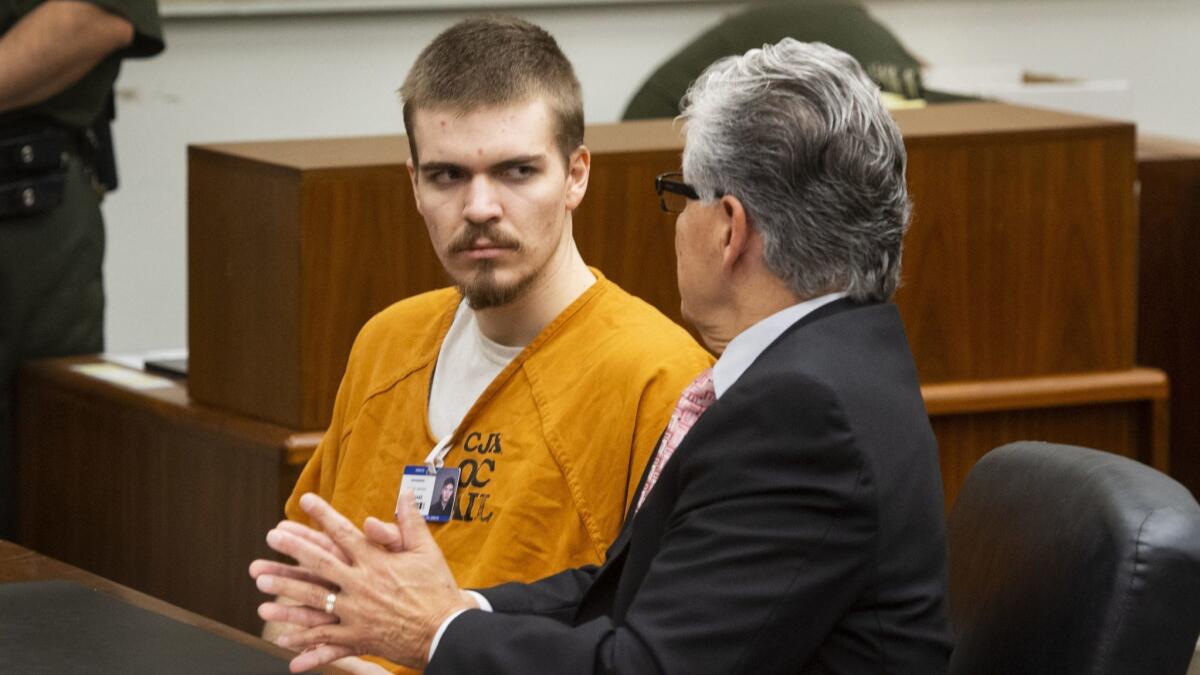 Samuel Woodward listens to his attorney, Edward Munoz, during a court hearing Wednesday.