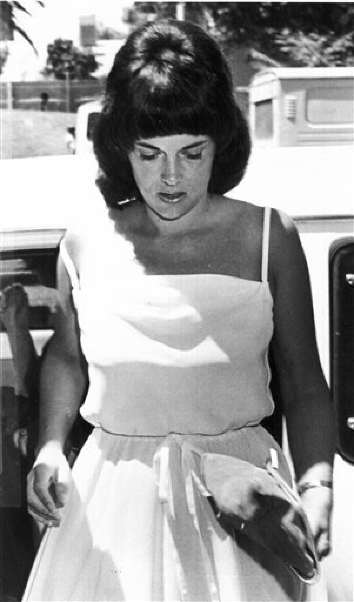 FILE - In this Feb. 2, 1982, file photo, Lindy Chamberlain appears outside Alice Springs courthouse. The Northern Territory coroner is opening a fourth inquest on Friday, Feb. 24, 2012 into the case of Chamberlain's 9-week-old daughter Azaria, who vanished from her tent in the Australian Outback in 1980. Chamberlain, who was accused and later cleared of killing Azaria, said a dingo took the baby. (AP Photo/File)