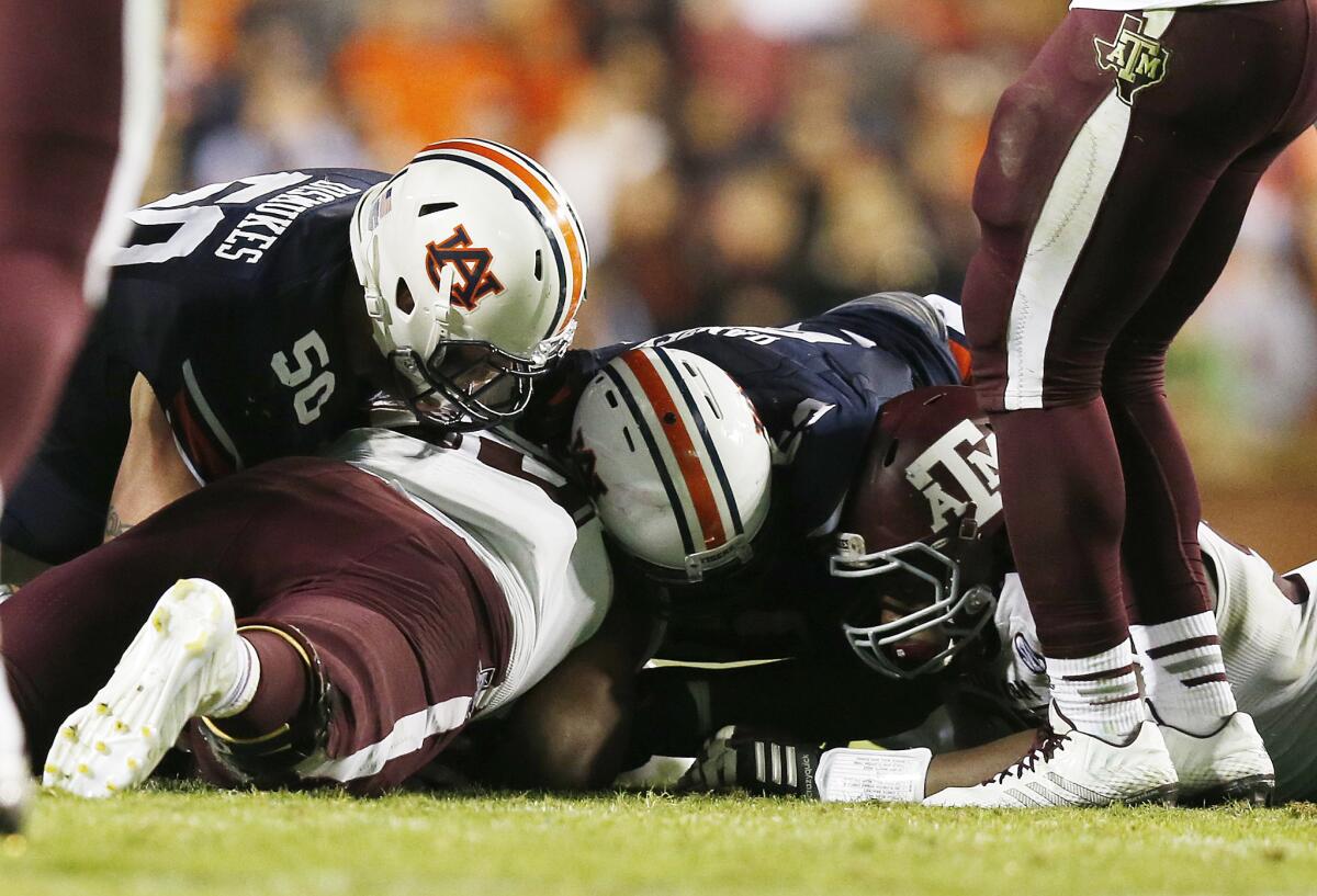 Auburn center Reese Dismukes (50) fumbles the ball and Texas A&M defensive lineman Alonzo Williams (83) recovers, ending any comeback hopes for the Tigers in their upset loss to the Aggies on Saturday.