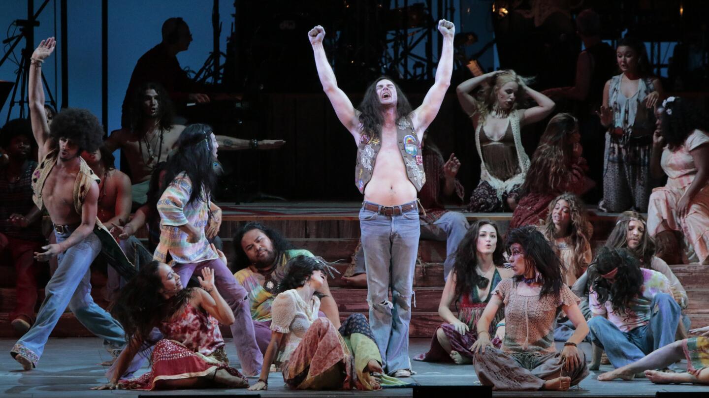 Benjamin Walker (center, arms up) as Berger and the ensemble in "Hair," the rock musical at the Hollywood Bowl on Aug. 1, 2014. The 1968 show celebrates the hippie counterculture, anti-war movement and sexual revolution of the 1960s with a rainbow score of musical hits.