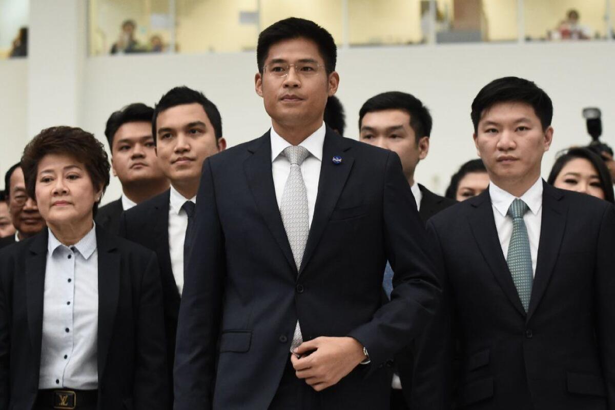 Thai Raksa Chart Party leader Preechapol Pongpanich, center, arrives at the Constitutional Court in Bangkok, March 7, 2019.