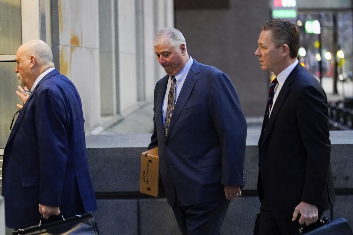 CORRECTS THAT PLANTS ARE FORMERLY OWNED BY FIRSTENERGY - Former Ohio House Speaker Larry Householder, center, walks into Potter Stewart U.S. Courthouse with his attorneys, Mark Marein, left, and Steven Bradley, right, before jury selection in his federal trial, Friday, Jan. 20, 2023, in Cincinnati. Householder and former Ohio Republican Party chair Matt Borges are charged with racketeering in an alleged $60 million scheme to pass state legislation to secure a $1 billion bailout for two nuclear power plantsformerlyowned by Akron, Ohio-based FirstEnergy. Householder and Borges have both pleaded not guilty. (AP Photo/Joshua A. Bickel)