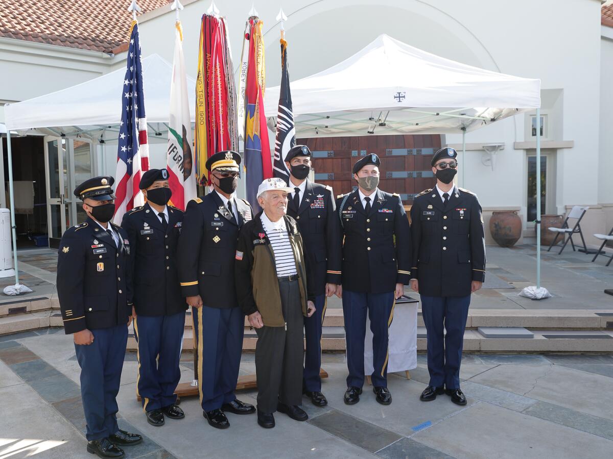 Representatives of the US Army 40th Infantry Division with Bronze Star honoree Bob Baker (center)