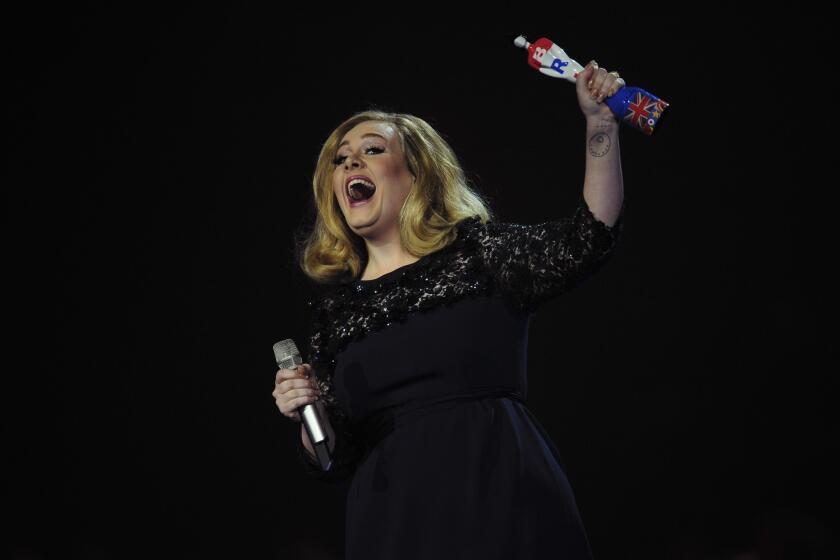 Adele, shown at the BRIT Awards in February, says that decades from now she'll be "telling people I was a Bond girl back in the day."