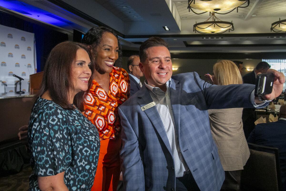 Deborah Wonderlech, Arthur Alderete and Julie Barreda pose for a selfie on Thursday. 