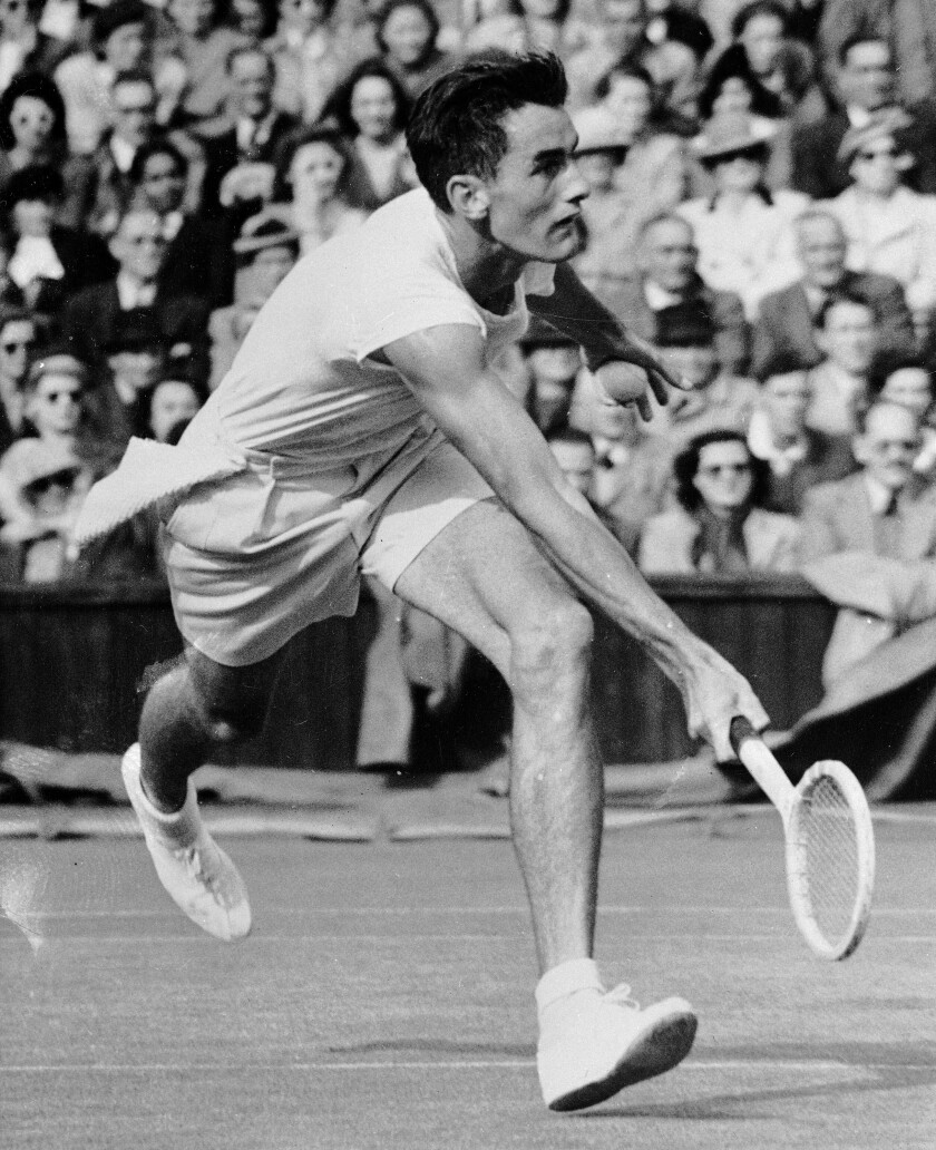 FILE - Bob Falkenburg, of Hollywood, Calif., makes a powerful forehand return during the All-American semifinal match against Gardnar Mulloy at Wimbledon, June 30, 1948. Falkenburg, who saved three championship points en route to winning the 1948 Wimbledon men’s singles final at age 22 and introduced fast food to Brazil during a post-tennis entrepreneurial career, has died. He was 95. Falkenburg passed away on Thursday, Jan. 6, 2022, from natural causes at his home in Santa Ynez, Calif., his daughter, Claudia, told The Associated Press in a phone interview Monday, Jan. 10, 2022. (AP Photo/File)