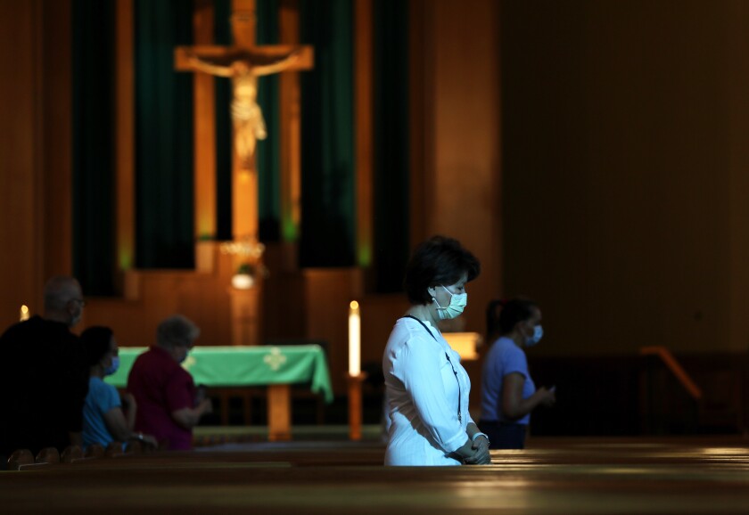  Parishioners attend Mass at San Gabriel Mission Church on Sunday.