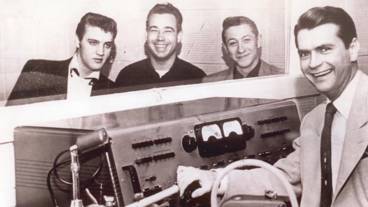 From left, Elvis Presley, bass player Bill Black, guitarist Scotty Moore and Sun Records and Memphis Recording studio head Sam Phillips pose during a recording session in Memphis, Tenn., in 1954. (Associated Press)