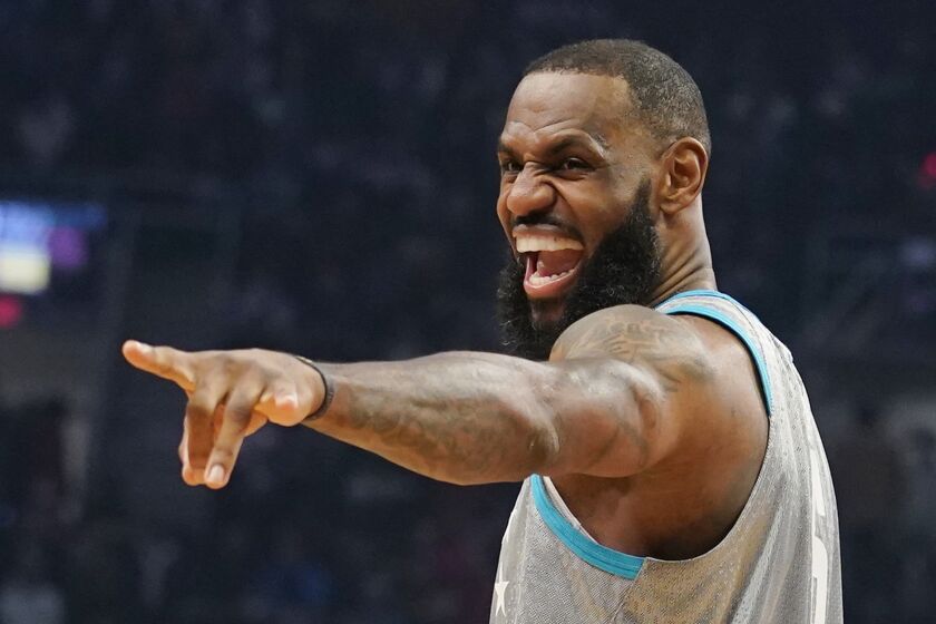 Los Angeles Lakers' LeBron James jokes with fans during the NBA All-Star game.