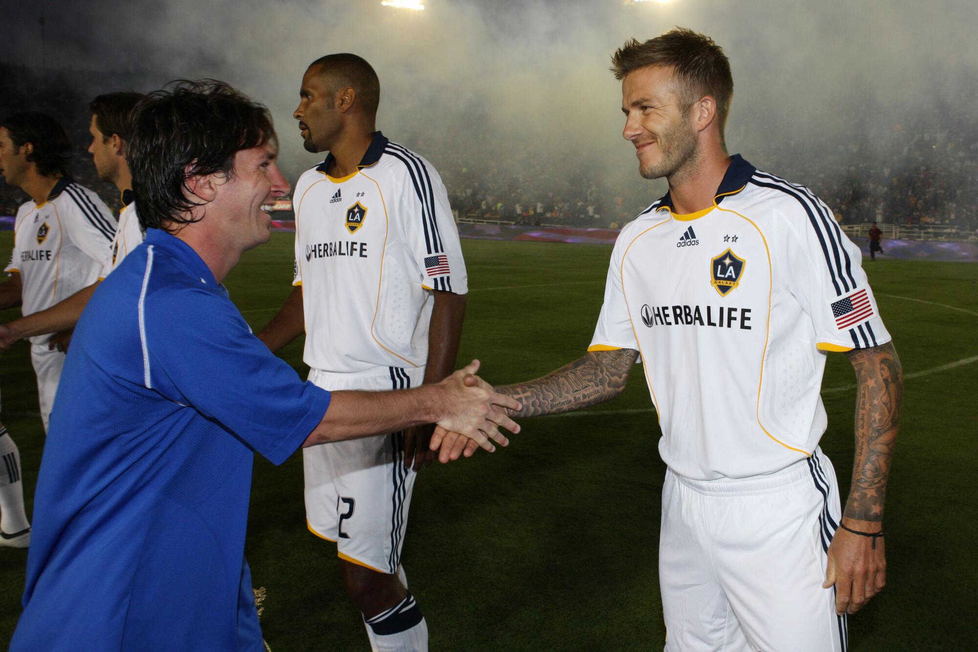 Lionel Messi shakes hands with David Beckham during a friendly match between FC Barcelona and the Galaxy at the Rose Bowl.