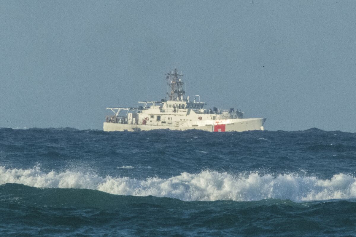 A U.S. Coast Guard cutter patrols the area of debris from a 737 cargo plane that crashed off Oahu, Friday, July 2, 2021, near Honolulu. The plane made an emergency landing in the Pacific Ocean off the coast of Hawaii early Friday and both people on board were rescued. The pilots of the Transair Flight 810 reported engine trouble and were attempting to return to Honolulu when they were forced to land the Boeing 737 in the water, the Federal Aviation Administration said in a statement. (Craig T. Kojima/Honolulu Star-Advertiser via AP)