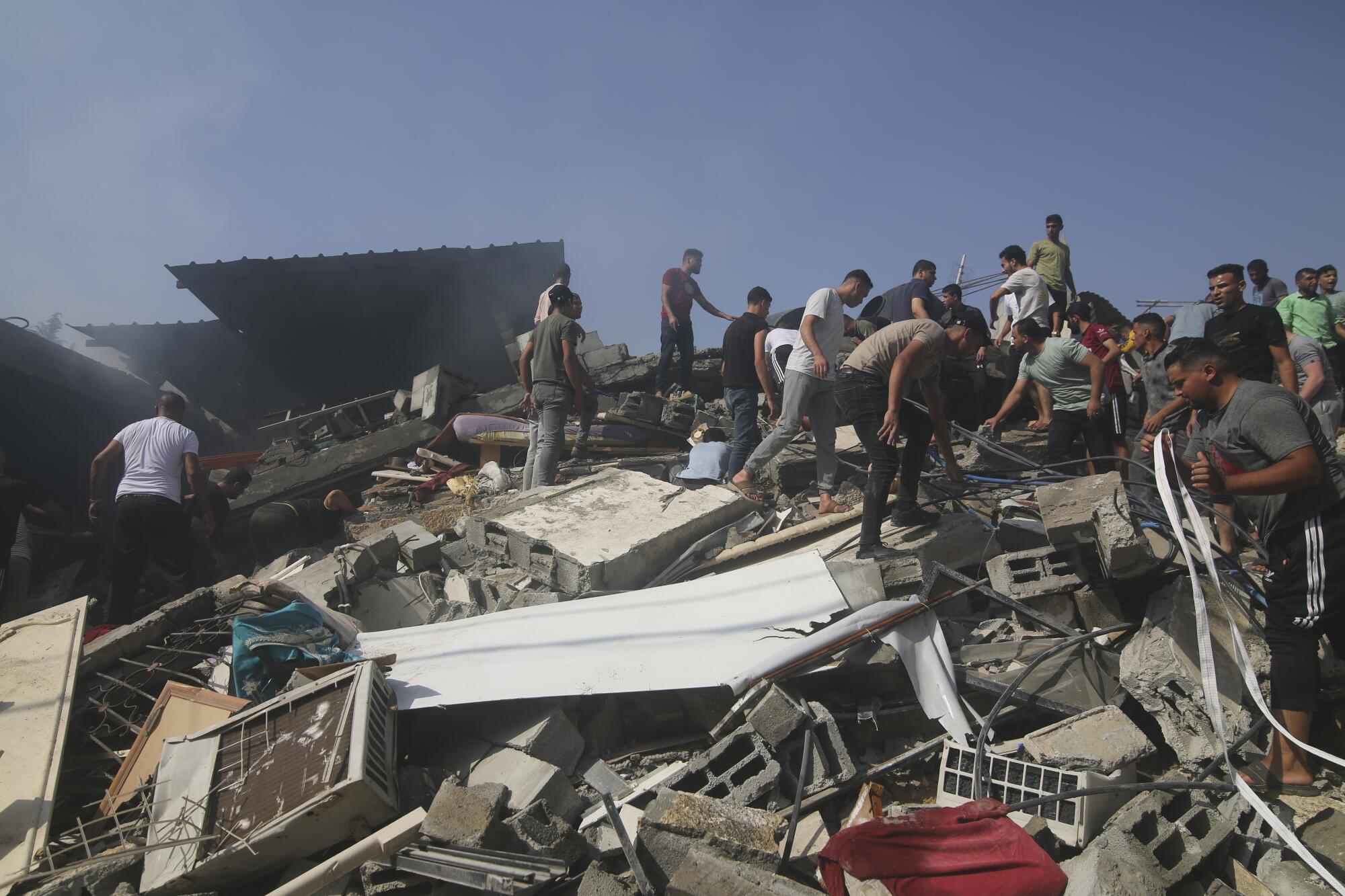 Palestinians looking for survivors of Israeli bombardment of Gaza