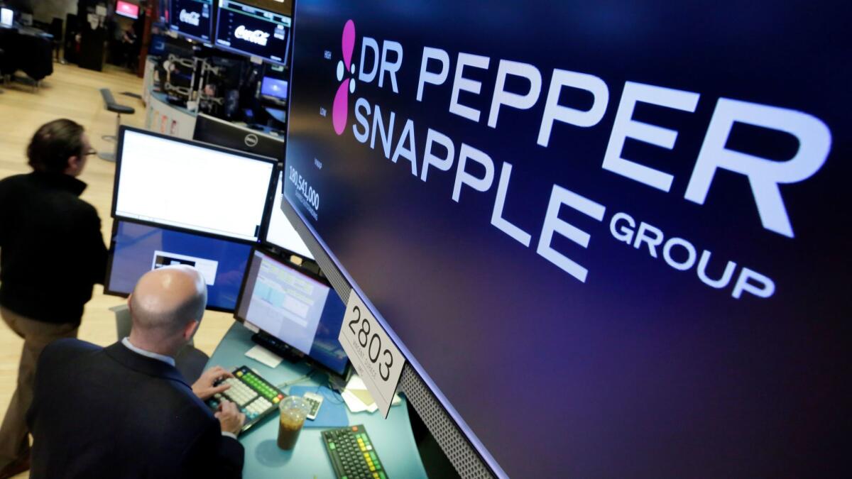 Dr Pepper Snapple Group soared 22.4% to $117.07 after it agreed to be acquired by Keurig for $16.6 billion, including debt. Above, on the floor of the New York Stock Exchange,
