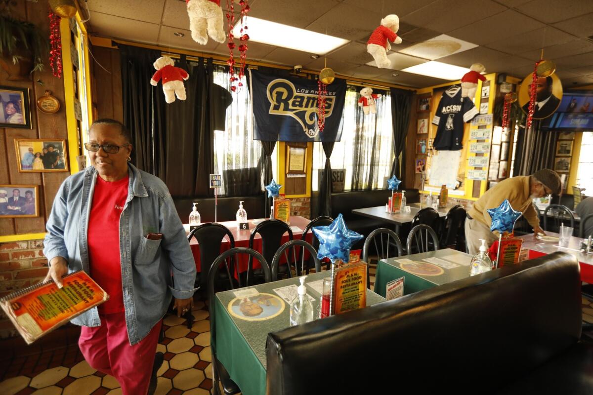 Beverly Brinson sets up favors for Sunday's Super Bowl party at her restaurant in Inglewood.