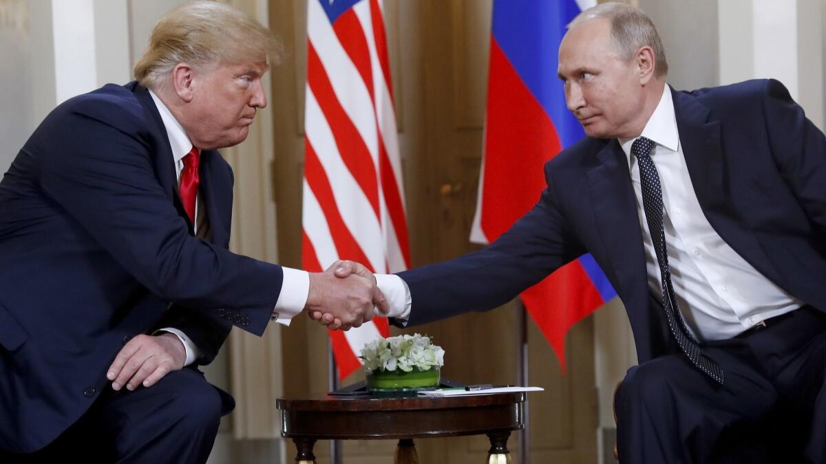 U.S. President Donald Trump, left, and Russian President Vladimir Putin shake hands at the beginning of a meeting at the Presidential Palace in Helsinki, Finland on July 16, 2018.