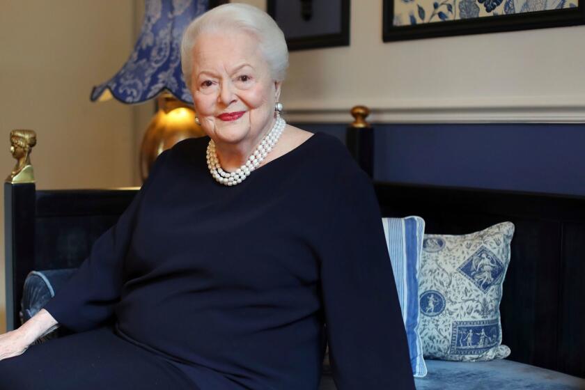 FILE - In this June 18, 2016 file photo, U.S. actress Olivia de Havilland poses during an Associated Press interview, in Paris. de Havilland is launching her own sequel to the TV series "Feud." The double Oscar-winning actress is suing FX Networks and producer Ryan Murphy's company, alleging unauthorized and false use of her name and invasion of privacy. The suit was filed in Los Angeles on Friday, June 30, 2017, one day before de Havilland turns 101. (AP Photo/Thibault Camus, File)