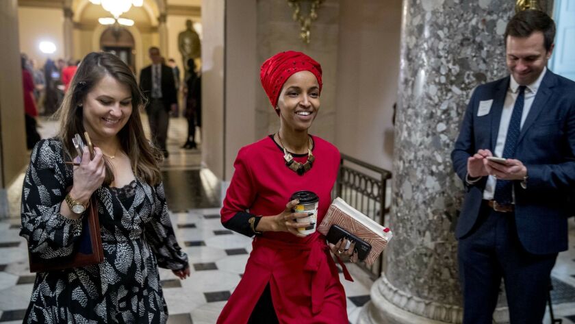 Rep. Ilhan Omar, D-Minn., center, walking through the halls of the Capitol Building in Washington in January, won't be allowed into Israel.