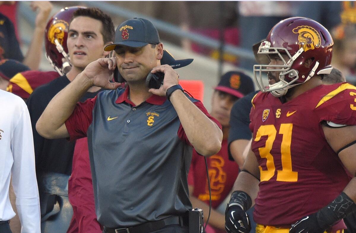 USC Coach Steve Sarkisian reacts to a penalty call as fullback Soma Vainuku watches during the first half of Sept. 19's game against Stanford at the Coliseum.
