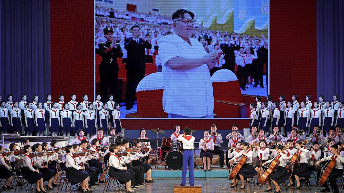 Young North Korean musicians perform against a backdrop image of leader Kim Jong Un. (Wong Maye-E / Associated Press)