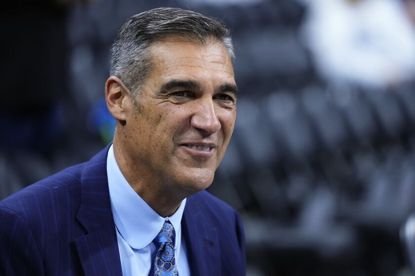 FILE - Former Villanova head coach Jay Wright smiles before an NCAA college basketball game between Villanova and Oklahoma, Saturday, Dec. 3, 2022, in Philadelphia. Jay Wright, the Hall of Fame coach who built Villanova from sleepy Big East school into a national power and won two national championships before he shocked the sport in April and retired at 60 after one last Final Four, is set to make his debut as a game analyst for CBS Sports on Wednesday night, Dec. 7, when his old Wildcats play Penn.(AP Photo/Matt Slocum, File)