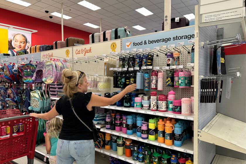 A woman reaches for a water bottle at a Target store.