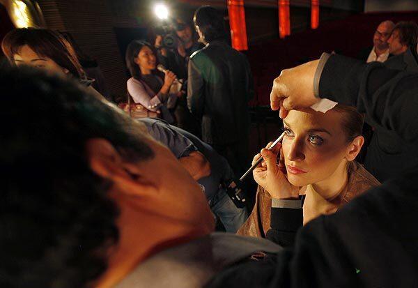 Model Brianna Barnes gets makeup from Bruce Grayson ahead of the Academy of Motion Picture Arts and Sciences' runway fashion show at its headquarters in Beverly Hills, showcasing competitors in this year's Oscar Designer Challenge, in which nine fashion designers vie to have an evening gown worn by an awards escort during the Oscars on Feb. 27. Members of the public are invited to vote to determine the winning design at www.oscar.com. Voting continues through Monday.